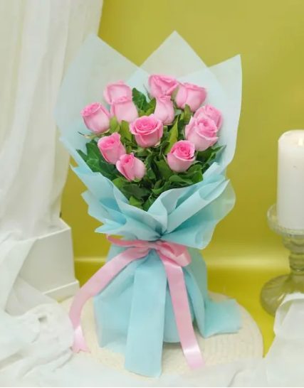 elegance of 8 pink roses wrapped in stunning blue paper