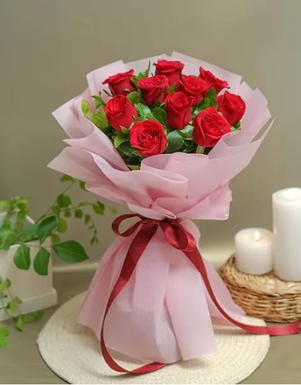 8 stunning red roses elegantly wrapped in pink paper