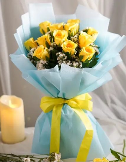 8 stunning yellow roses wrapped in elegant blue paper